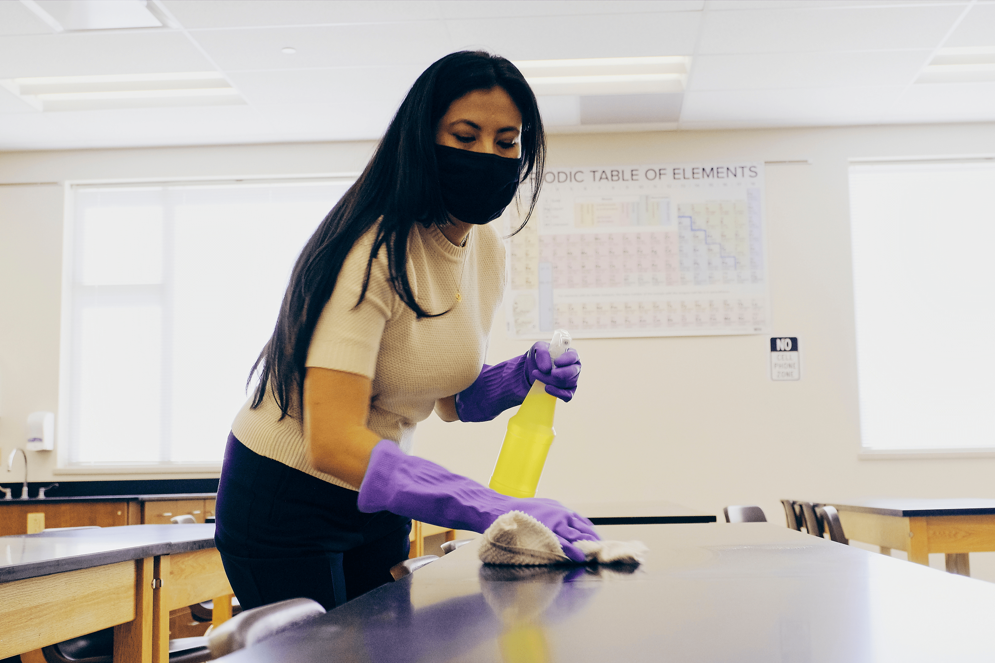 a woman cleaning a school to create a cleaner environment