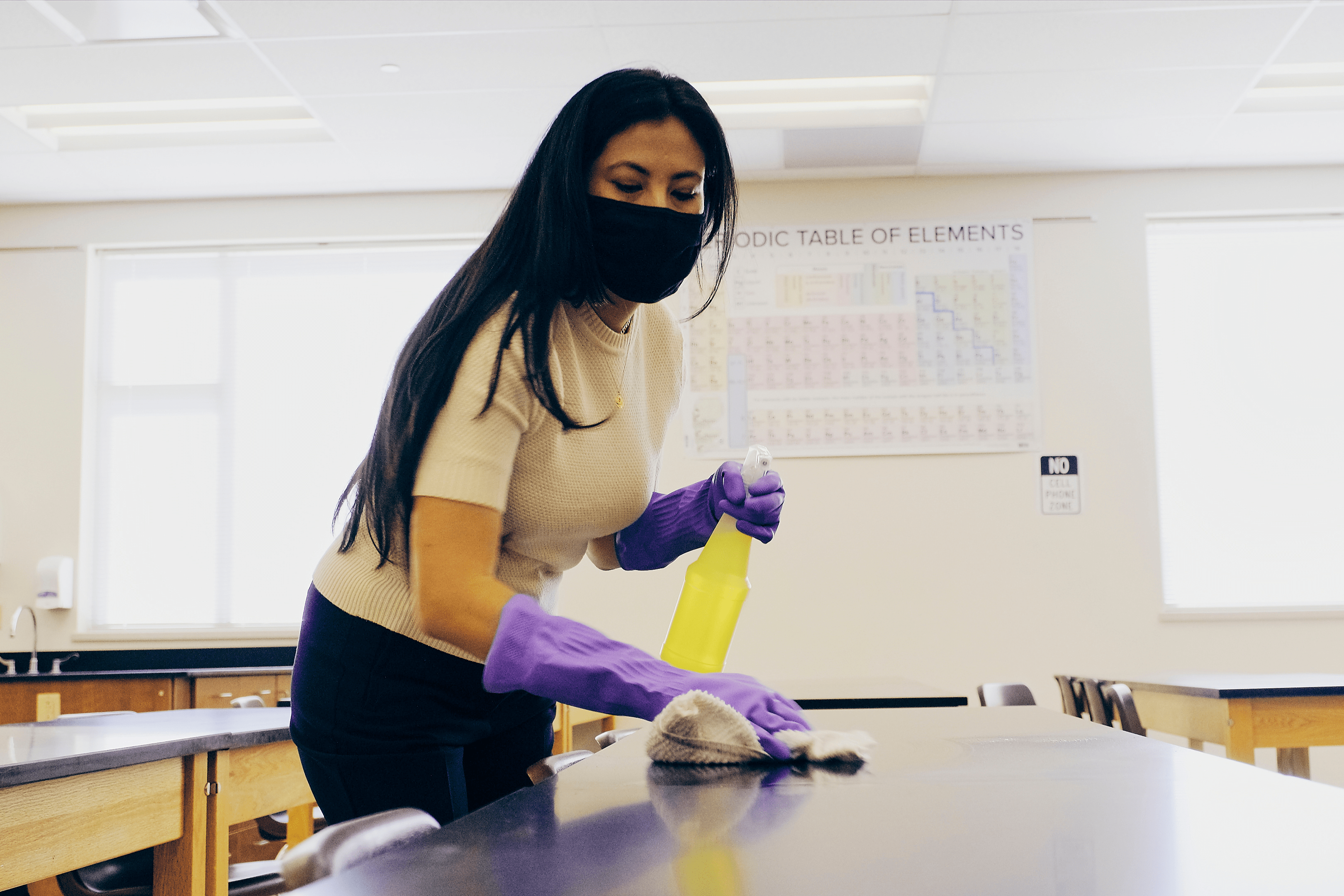 a woman cleaning a school to create a cleaner environment  